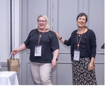 Nastassja (left), winning the best poster award at the VALIDATE Annual Meeting 2025