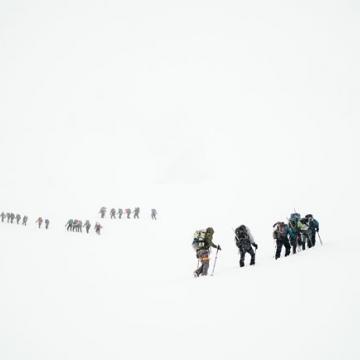 Teams climbing a mountain