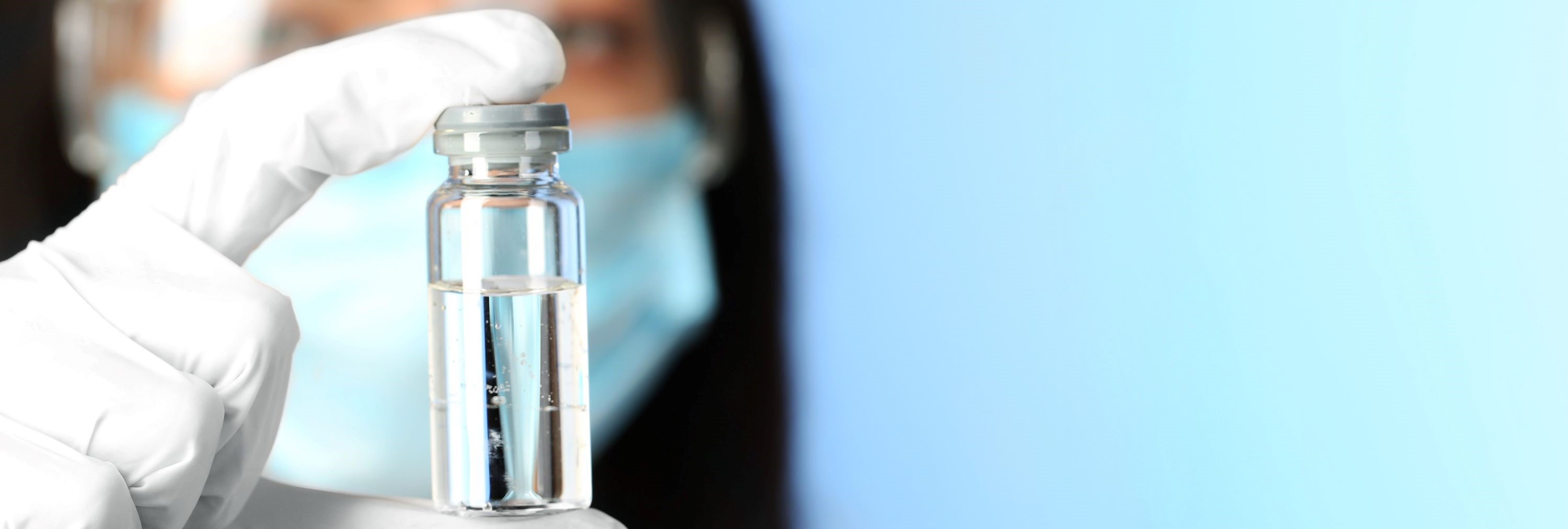 Scientist holding a vaccine vial