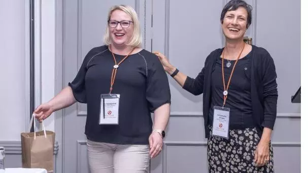 Nastassja (left), winning the best poster award at the VALIDATE Annual Meeting 2025