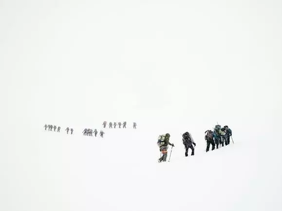 Teams climbing a mountain