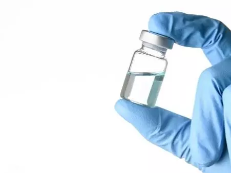 Scientist holding vaccine vial