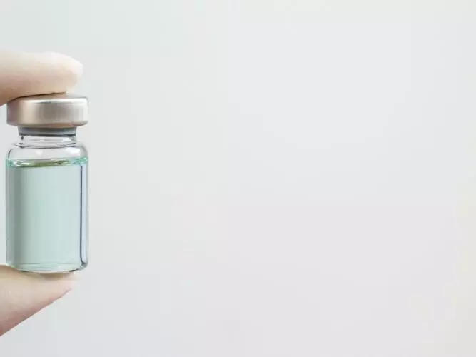 Vaccine Vial being held