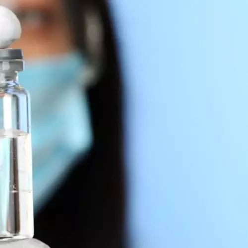 Scientist holding a vaccine vial