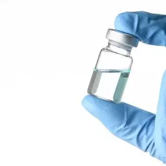 Scientist holding vaccine vial