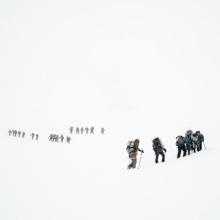 Teams climbing a mountain